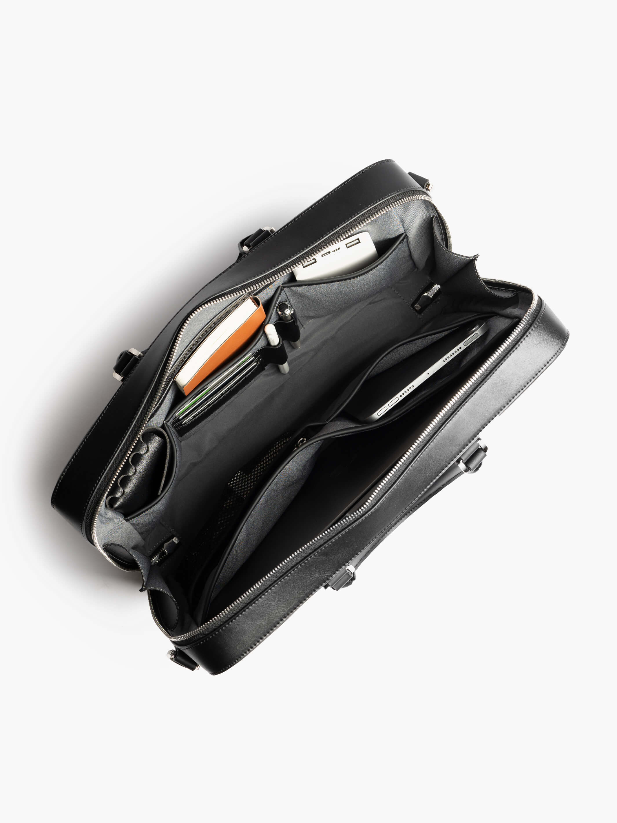 Maverick & Co. - Delta Leather Briefcase Interior view of Delta Leather Briefcase showing dedicated slots for daily essentials and 16-inch laptop capacity. #color_black