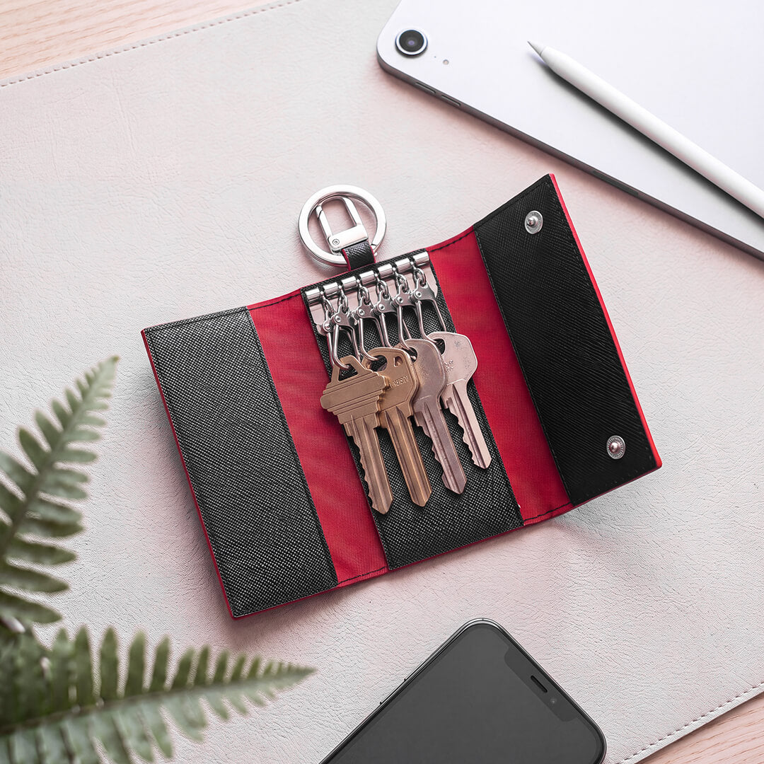 Maverick & Co. - Manhattan Leather Key Case - open on a desk beside tablet and phone